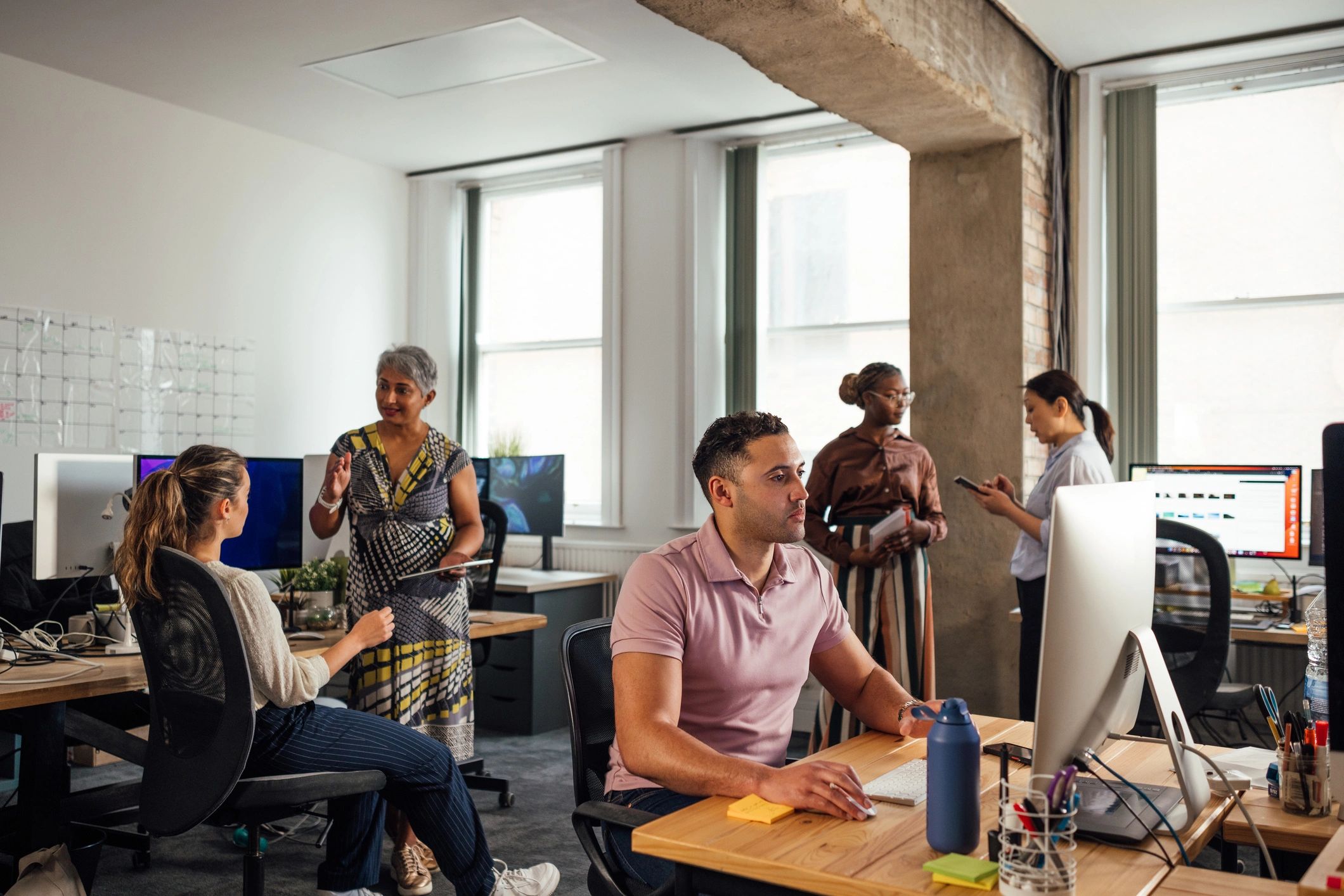 Office team working together on computers